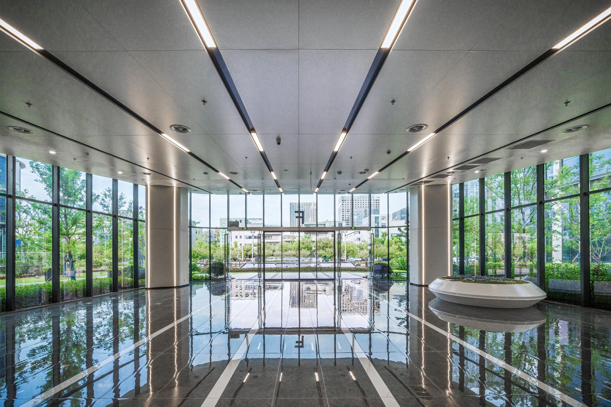 An office building lobby with panoramic windows and polished floors